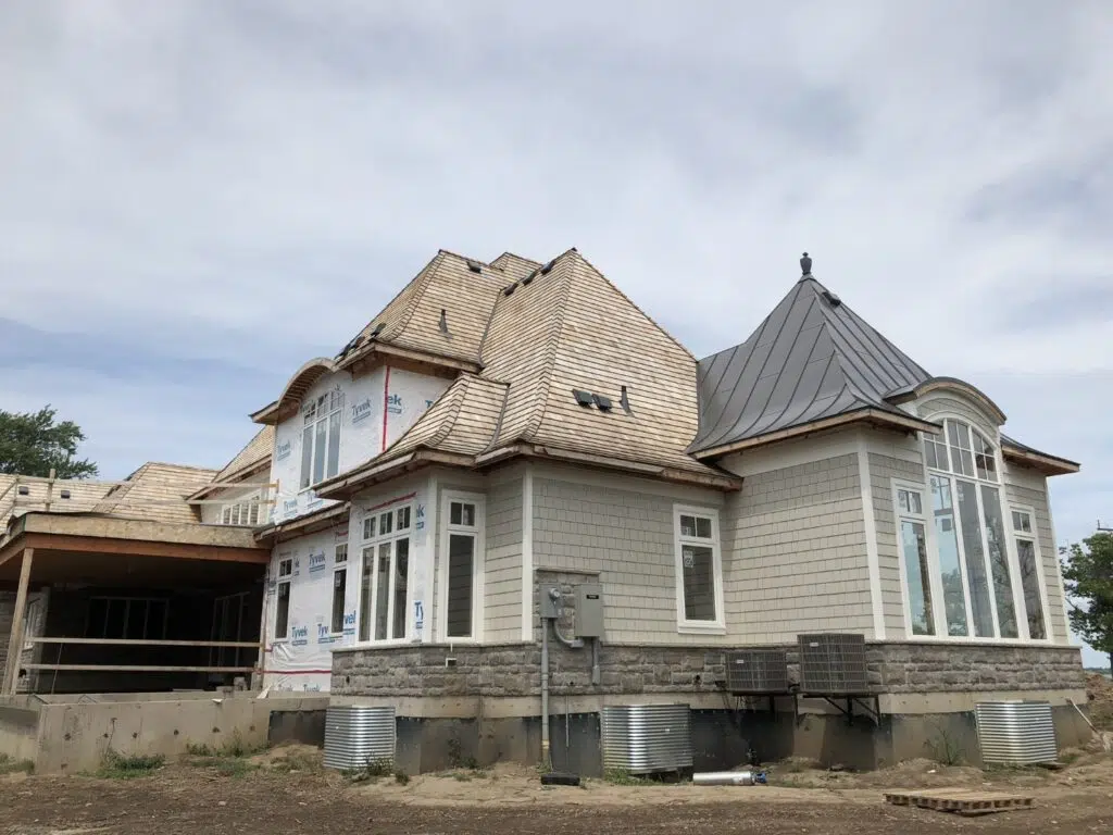 Fort Erie, Niagara River French Chateau architecture, curved dormers, steep peaks, metal turret installation cedar roofing siding - during cons